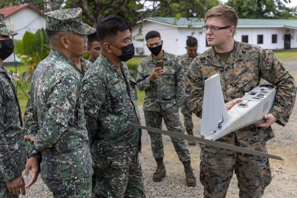 Left: U.S. Marines and Philippine Marines participate in a small unmanned aircraft systems exchange during Marine Aviation Support Activity (MASA) 22 in Palawan.